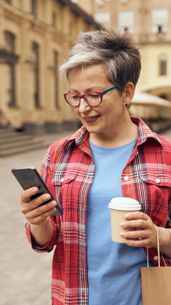 a woman is joyfully enjoying her coffee while usin 2024 08 16 12 39 17 utc - Universidade Marketplaces