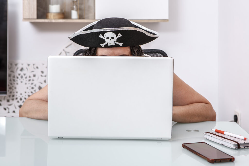 Pirate-Themed Hacker Engaging in Online Scams at a Modern Home O